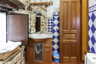 a bathroom with a sink and a mirror at Spacious House with Jacuzzi, Mountain View near Tineo in Tineo