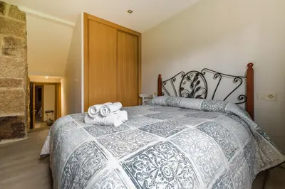 a bedroom with a bed with towels on it at Gran Casa Rural A Touza in Ourense