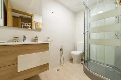 a bathroom with a glass shower and a toilet at Gran Casa Rural A Touza in Ourense