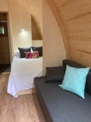 a bedroom with two beds and a couch at Camping Vila de Sarria in Sarria