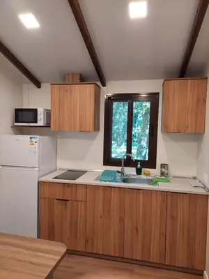 a kitchen with a sink and a refrigerator at Camping Vila de Sarria in Sarria