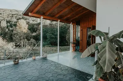 a porch of a house with a view at Hotel A Veiga in Samos