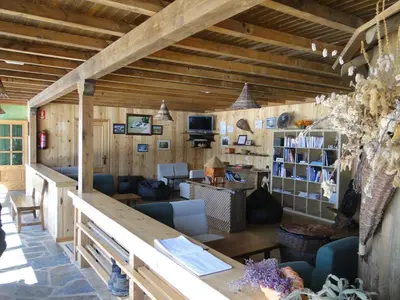 a living room with wooden walls and a wooden ceiling at A Reboleira - Casa Nuñez in Fonfría