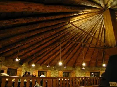 a large wooden ceiling in a room with people at A Reboleira - Casa Nuñez in Fonfría