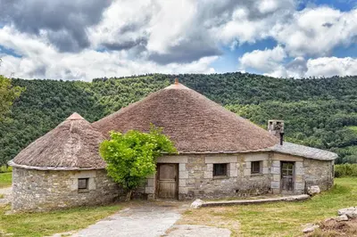 an old stone building with a grass roof at A Reboleira - Casa Nuñez in Fonfría