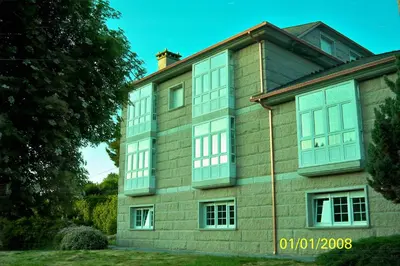 a building with many windows on the side of it at POSTA Do SOL in Baralla