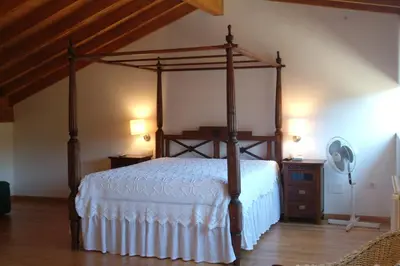 a bedroom with a canopy bed and a dresser at Casa Rural Vilaboa in Allariz