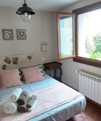 a bedroom with a bed with towels on it at Apartamento Cine Colón 2 in Ribadeo