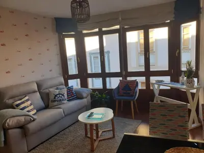 a living room with a couch and a table at Apartamento Cine Colón 2 in Ribadeo