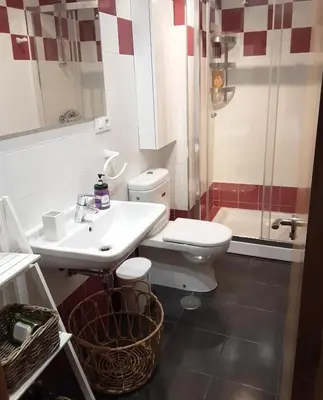 a bathroom with a toilet and a sink and a shower at Apartamento Cine Colón 2 in Ribadeo