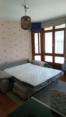 a hospital bed in a room with windows at Apartamento Cine Colón 2 in Ribadeo