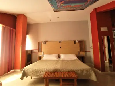 a bedroom with a large bed with a wooden headboard at Hotel Castillo del Alba in Pola de Somiedo