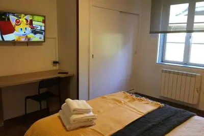 a bedroom with a bed with two towels on it at PISO A 400 METROS DE LA CATEDRAL in Santiago de Compostela