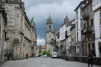 a city street with a building with a clock tower at PISO A 400 METROS DE LA CATEDRAL in Santiago de Compostela