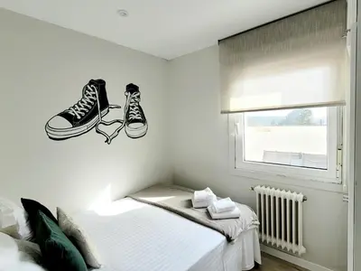a bedroom with a pair of shoes on the wall at Acogedor apartamento a la entrada de camino portugués in Santiago de Compostela