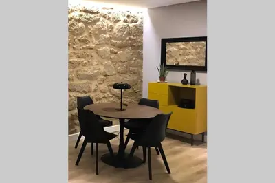 a dining room with a table and chairs and a yellow cabinet at Plaza Mayor in Ourense