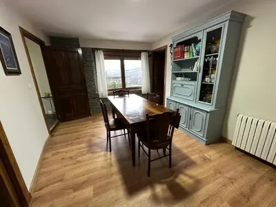 a dining room with a wooden table and chairs at La Casa del Maestro in Rabanal