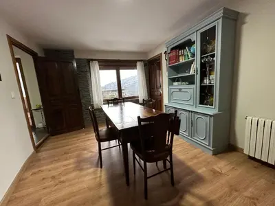 a dining room with a wooden table and chairs at La Casa del Maestro in Rabanal