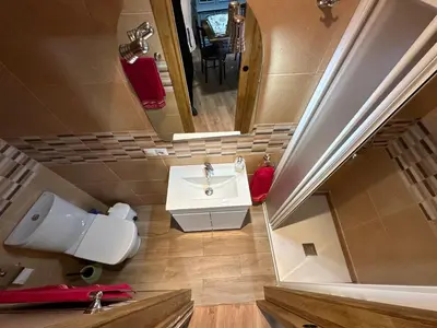a bathroom with a sink and a toilet and a mirror at La Casa del Maestro in Rabanal