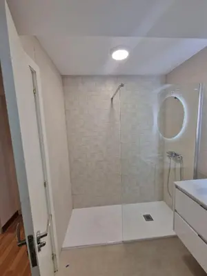 a bathroom with a shower with a glass door at Amplio piso con terraza en el Camino y Catedral in Santiago de Compostela