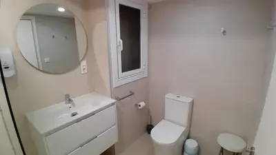 a bathroom with a sink and a toilet and a mirror at Amplio piso con terraza en el Camino y Catedral in Santiago de Compostela