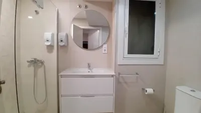 a white bathroom with a sink and a mirror at Amplio piso próximo a la Catedral y el Camino. C2 in Santiago de Compostela