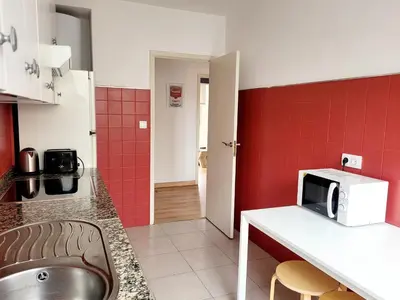 a kitchen with a sink and a microwave on a counter at AMPLIO PISO LUMINOSO CERCA DEL CAMINO Y CATEDRAL C3 in Santiago de Compostela