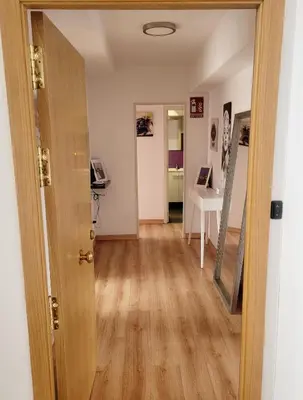 an open door into a room with a hallway at AMPLIO PISO LUMINOSO CERCA DEL CAMINO Y CATEDRAL C3 in Santiago de Compostela