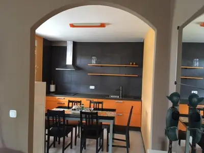 a kitchen with a table and chairs in a room at Apartamentos Rurales San Xillao in Ribadeo