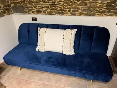 a blue couch with a white pillow on it at Casa Ferreiro - Campo da Cruz - Lugo in Baltar