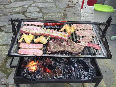 a grill with many different types of meat on it at Casa Ferreiro - Campo da Cruz - Lugo in Baltar
