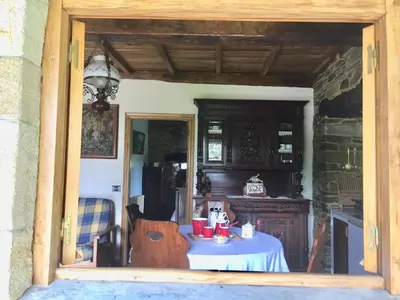 a kitchen with a table in a doorway at Casa Ferreiro - Campo da Cruz - Lugo in Baltar