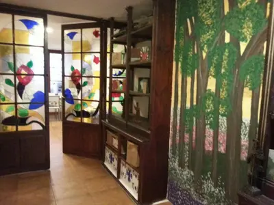 a room with stained glass doors and paintings on the walls at Obradoiro in Sarria