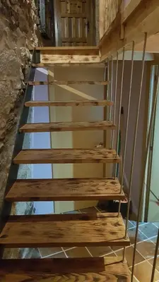 a set of wooden stairs in a room at A Paragűeria in Sas de Penelas