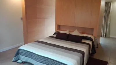 a bedroom with a large bed with a wooden headboard at PR Albeitaría in Reis