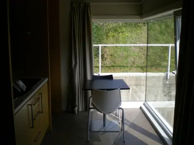 a table and a chair in front of a window at PR Albeitaría in Reis