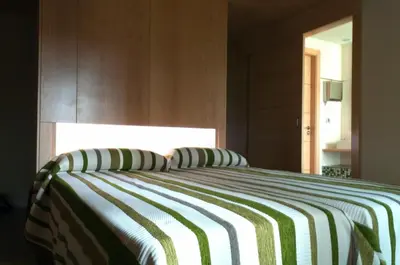 a bedroom with a bed with a striped blanket at PR Albeitaría in Reis