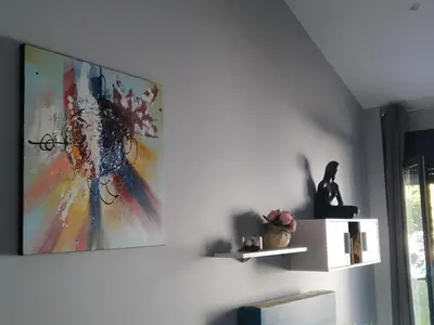 a living room with a painting on the wall at Carballos Altos-Apartamentos Turísticos in Arzúa