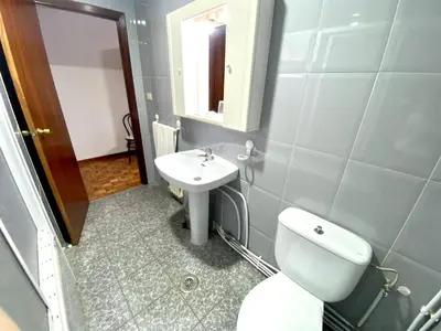 a bathroom with a white toilet and a sink at Garden Lodge Hostal Evencio in Ribadavia