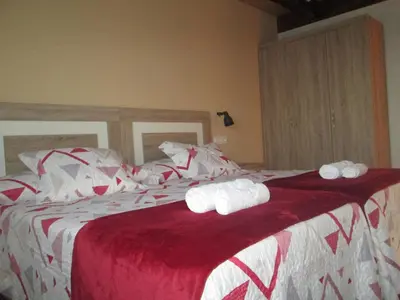a bedroom with a bed with two rolled towels on it at APARTAMENTOS FONTE VILLAR in Navia