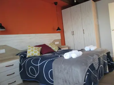 a bedroom with a bed with towels on it at APARTAMENTOS FONTE VILLAR in Navia
