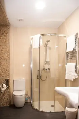 a bathroom with a shower and a toilet and a sink at Linares Rooms Santiago in Santiago de Compostela