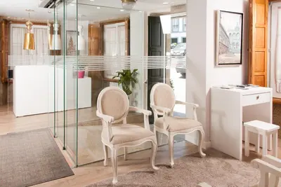 two chairs in a room with a glass wall at Linares Rooms Santiago in Santiago de Compostela