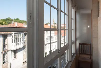 a window with a view of a building at Linares Rooms Santiago in Santiago de Compostela