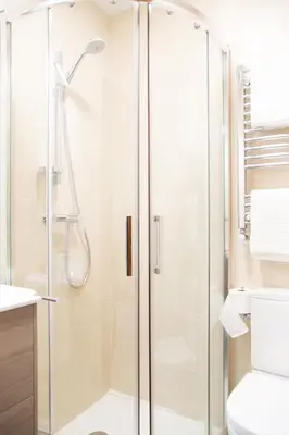 a shower with a glass door in a bathroom at Linares Rooms Santiago in Santiago de Compostela