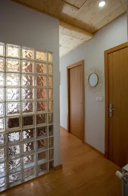 a room with a wall of wine bottles at Casa Chuss in Sober