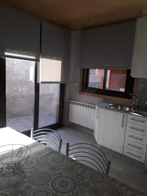 a kitchen with a table and chairs and a table and a counter at Casa Chuss in Sober
