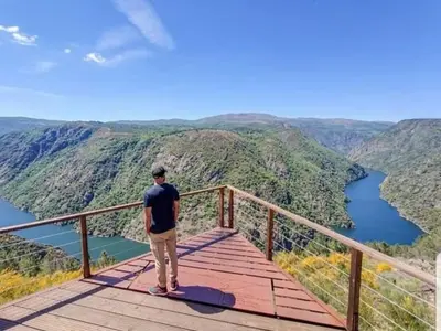 a man standing on top of a wooden boardwalk at Casa Chuss in Sober