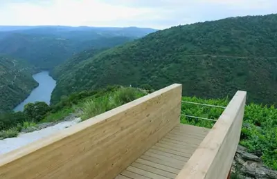 a wooden boardwalk on top of a mountain with a river at Casa Chuss in Sober