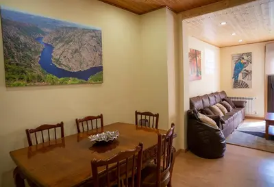 a dining room with a table and a couch at Casa Chuss in Sober